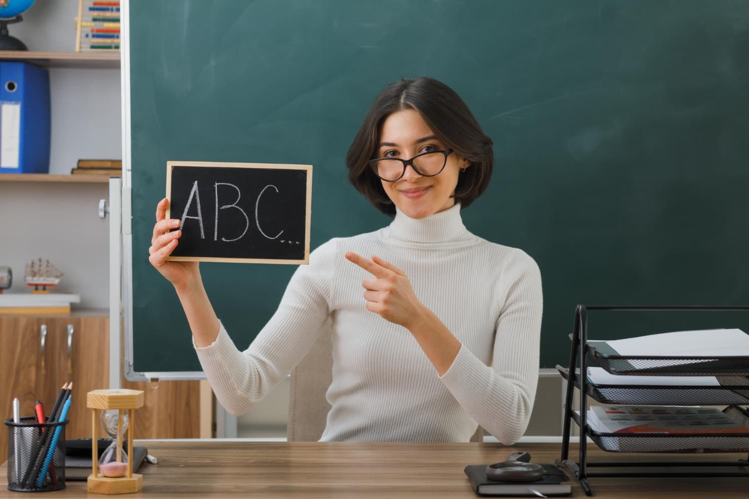 Teacher with ABC chalkboard
